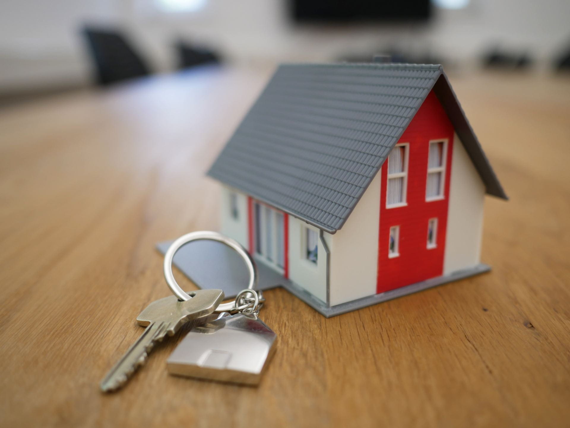 a small model of a house and a set of keys